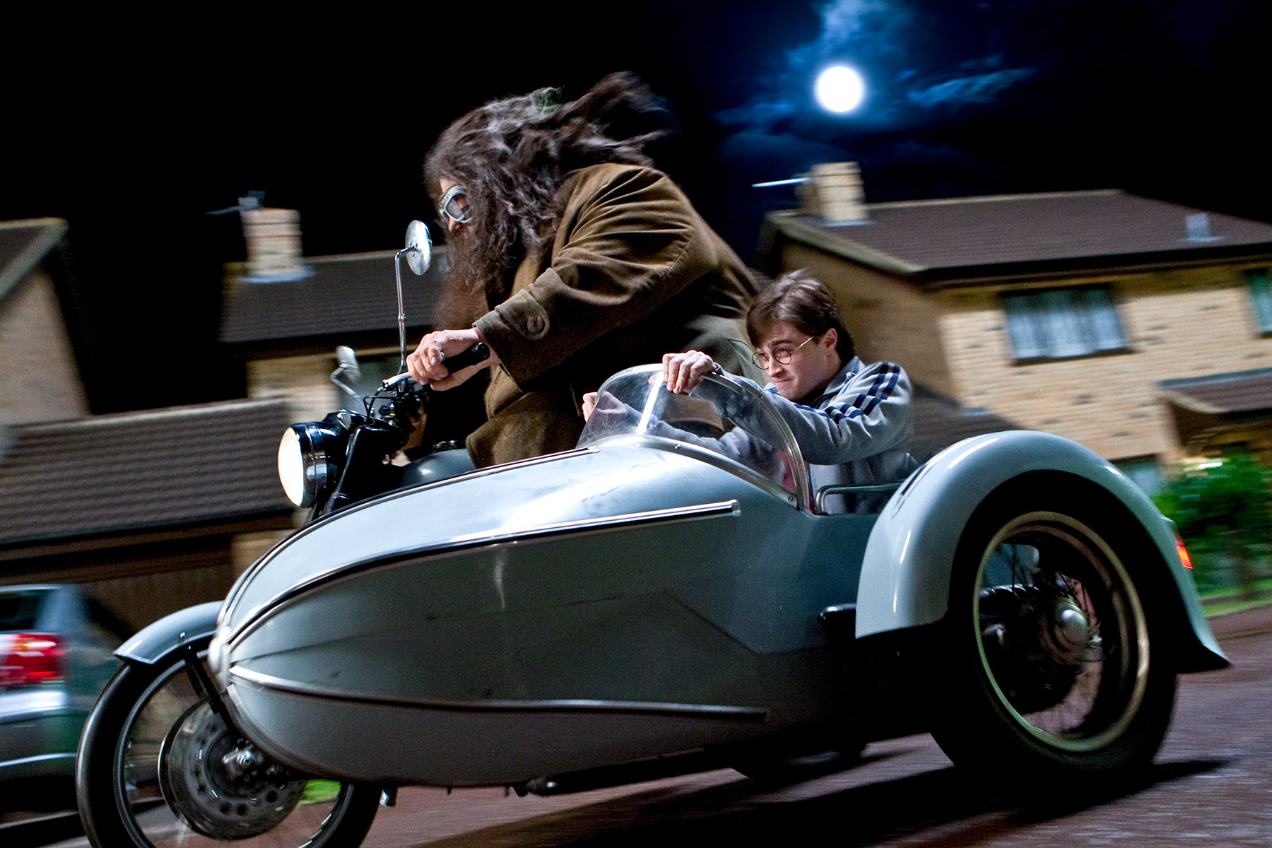 Everyone mounts up and leaves Privet Drive. Harry and Hagrid (Greg Powell) take the bike. (SC22)